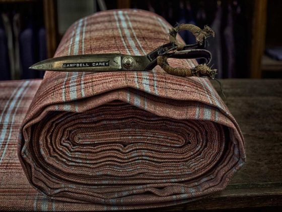 Savile Row Scissors on a roll of tweed fabric