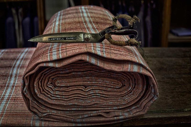 Savile Row Scissors on a roll of tweed fabric